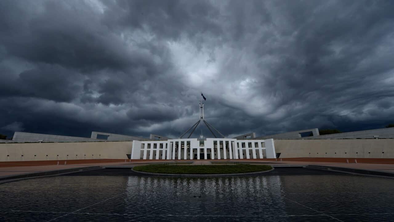 Storm clouds are seen building up over Parliament House in Canberra, Wednesday, Feb. 19, 2014. Canberra has been hit by strong rain and winds. (AAP Image/Lukas Coch) NO ARCHIVING