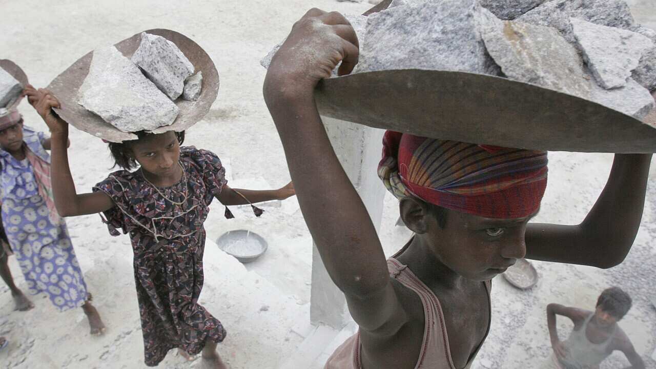 Child labourers carry stones on their head at a stone crusher on the outskirts of Gauhati, India, June 11, 2008. (AP Photo/Anupam Nath)