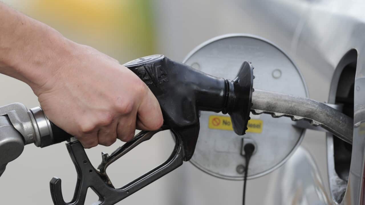 A man pumps petrol at a service station