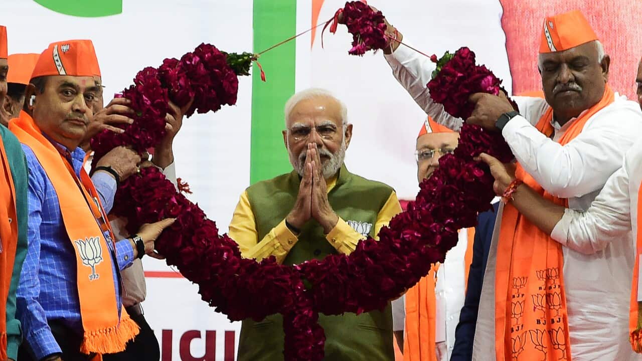 Indian Prime Minister Narendra Modi (C) gestures during a Bhartiya Janta Party (BJP) rally ahead of 2nd phase of Gujarat's assembly election, in Ahmedabad on December 2, 2022.