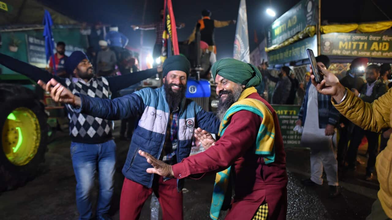 Farmers celebrate after the SKM leaders announced to call off the agitation, at Singhu Border, on 9 December, 2021 in New Delhi, India.