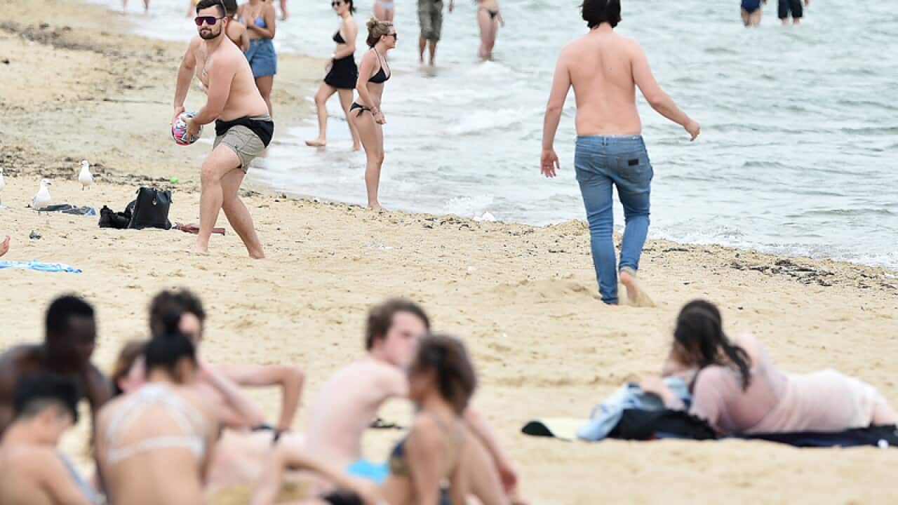 Beachgoers are seen at St. Kilda beach