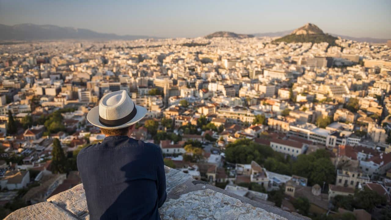 man looking at view over Athens from Likavitos Hill, at The Acropolis, Attica Region, Greece, Europe