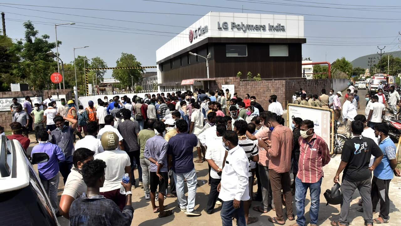 A crowd gathers outside the LG Polymers plant from where chemical gas leaked in Vishakhapatnam, India, Thursday, May 7, 2020.