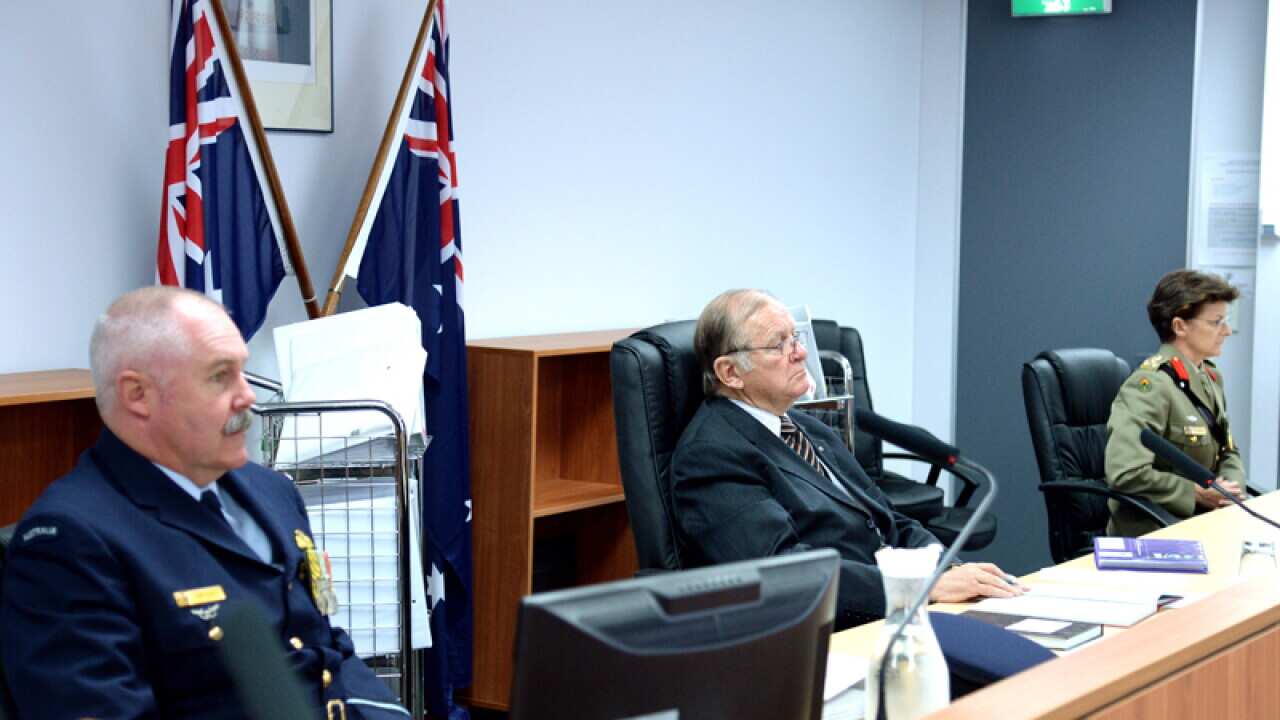 John O'Meally (C) presides over a defence inquiry