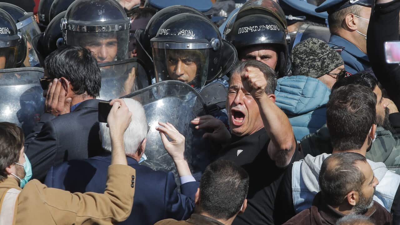 People argue with police during a protest in Freedom Square in Yerevan, Armenia, Wednesday, Nov. 11, 2020.