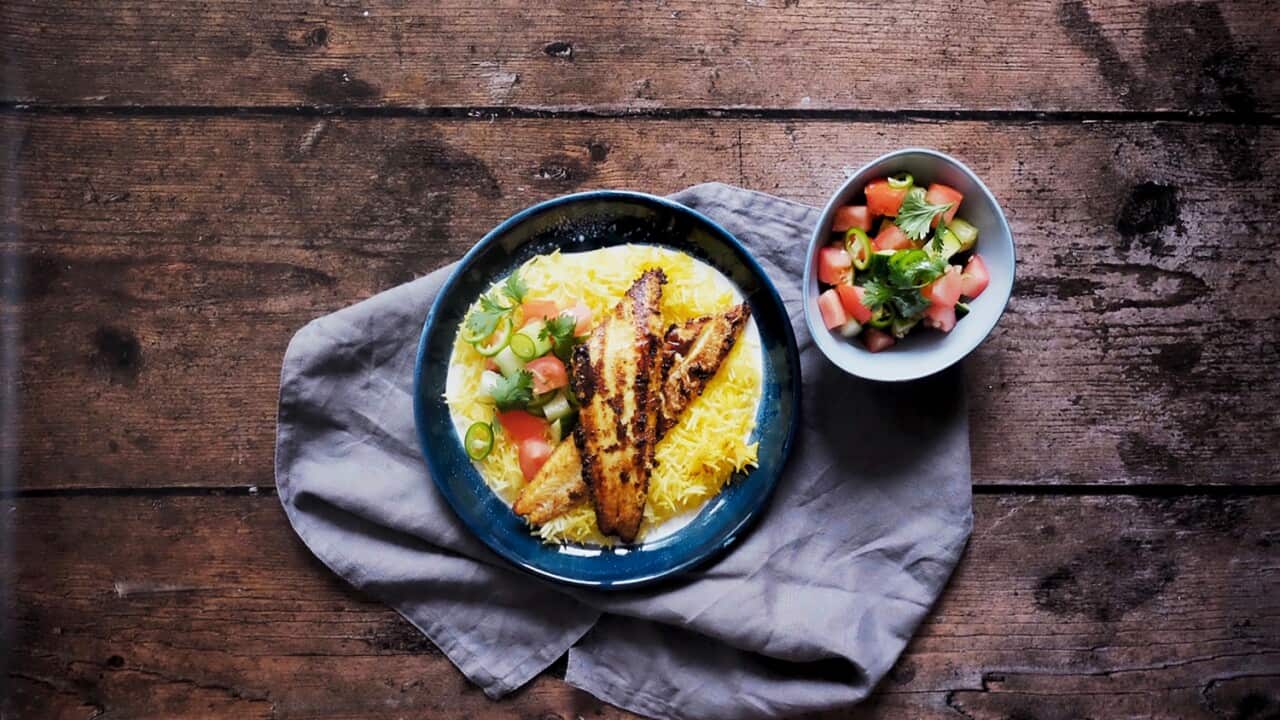 Turmeric yoghurt grilled fish on saffron rice, with a refreshing tomato and cucumber chopped salad on the side.