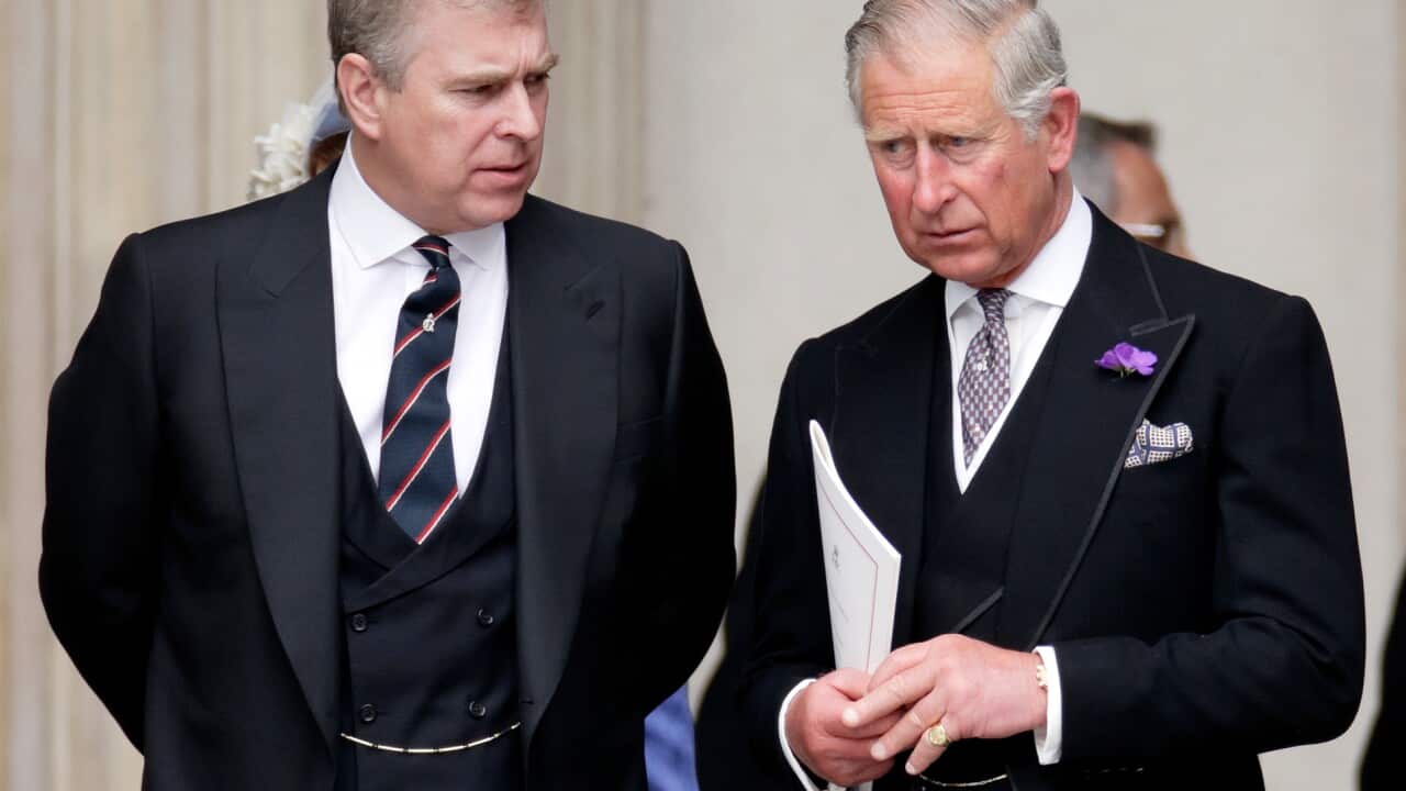Andrew Mountbatten-Windsor and King Charles standing next to each other, both wearing black suits.