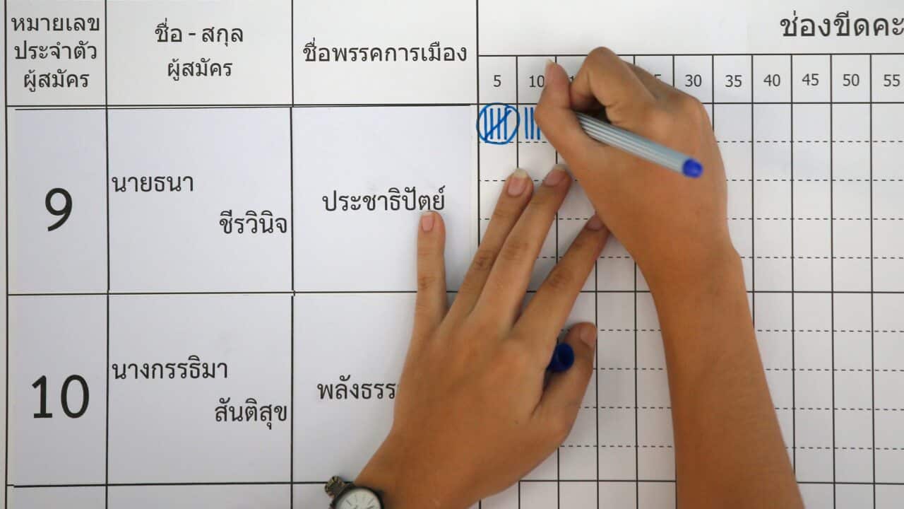 A Thai election officer marks vote count as counting commenced at a polling station in Bangkok, Thailand.