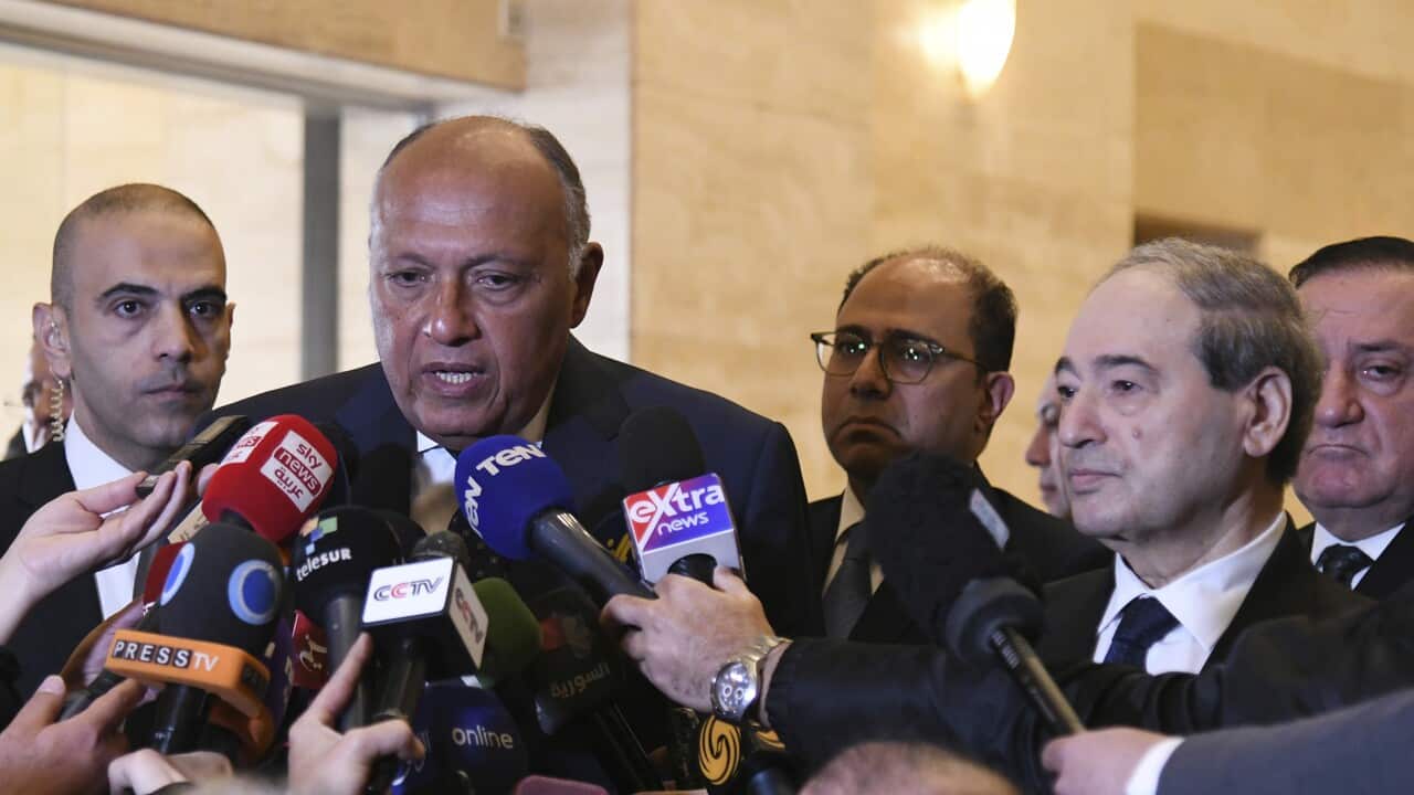 Egyptian Foreign Minister Sameh Shoukry, left, speaks with journalists after his meeting with Syrian Foreign Minister Faisal Mekdad, right, in Damascus