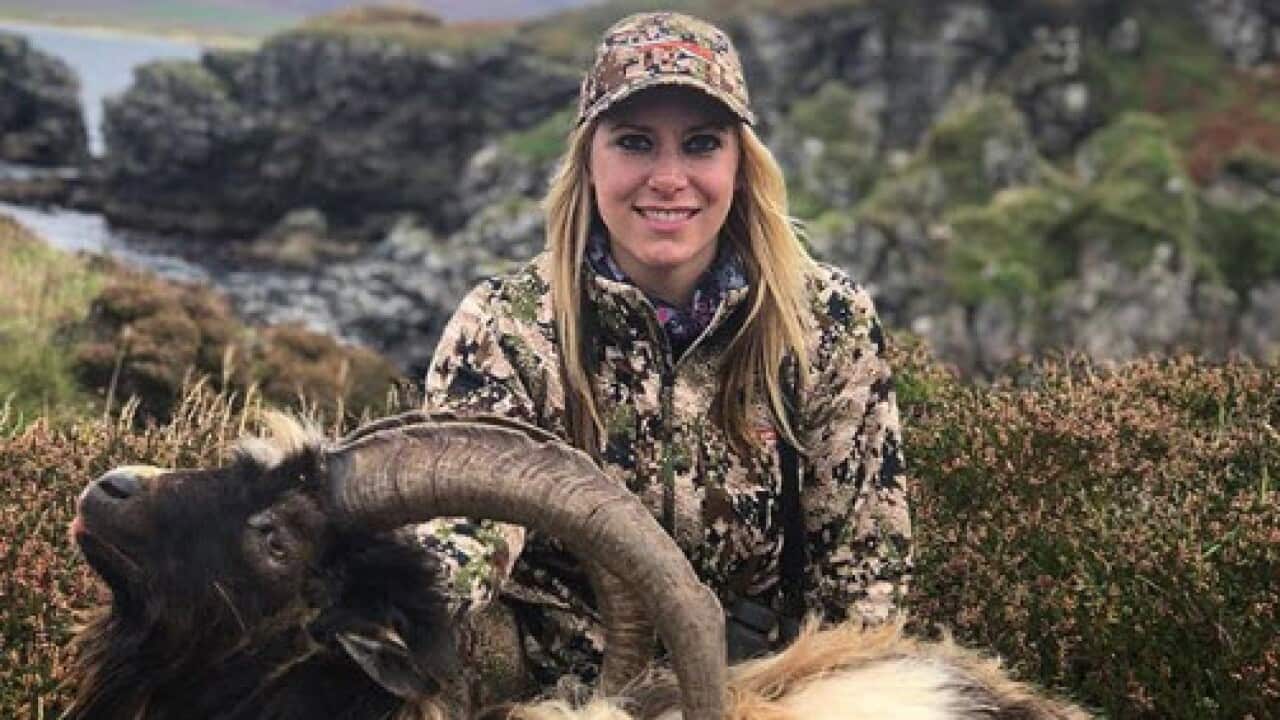 Larysa Switlyk posing with a dead wild goat.