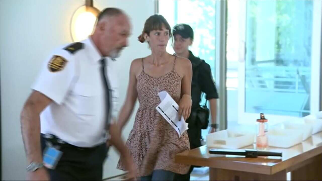 On of the climate change protest group is escorted out by security.