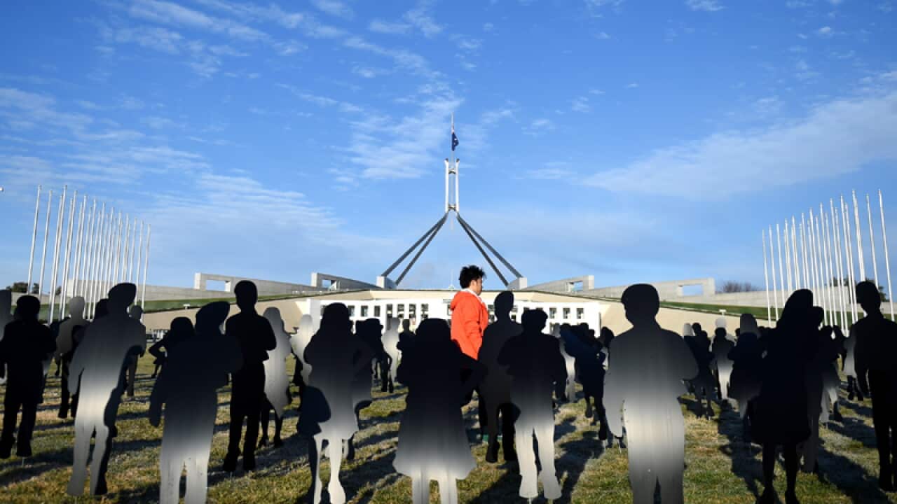 An installation of silhouettes of children outside Parliament House