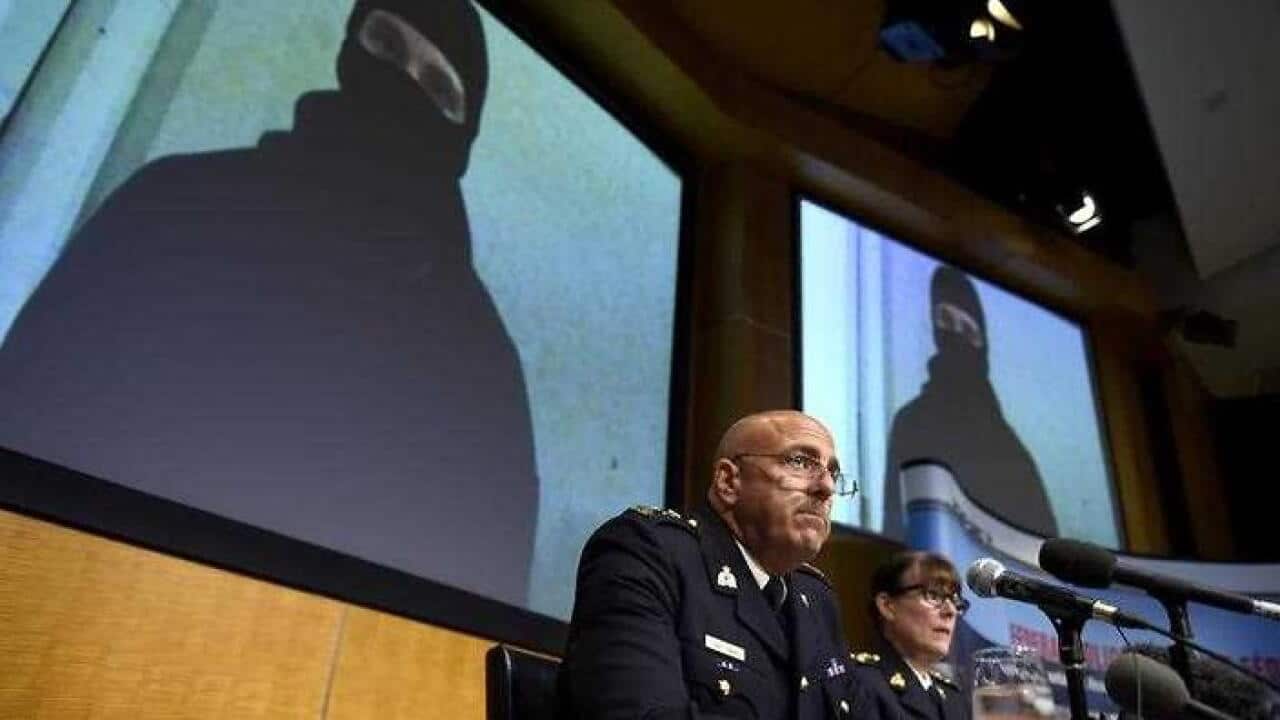 Video footage showing Aaron Driver is seen behind Royal Canadian Mounted Police (RCMP) Deputy Commissioner Mike Cabana (AAP)