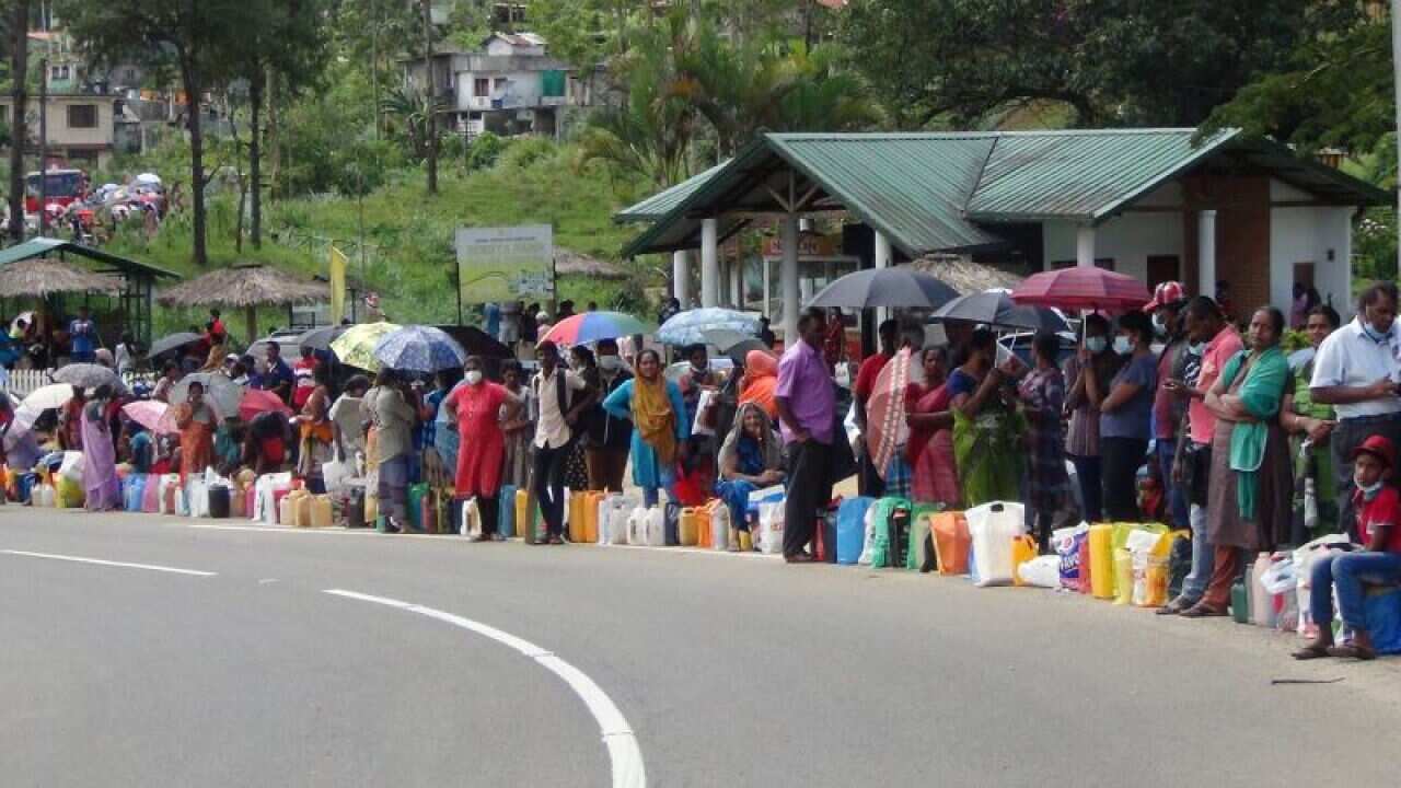 People standing in queues for essentials
