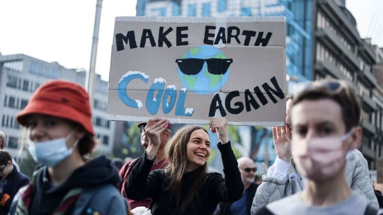 Protesters take part in a demonstration in Brussels ahead of the COP26 climate summit.