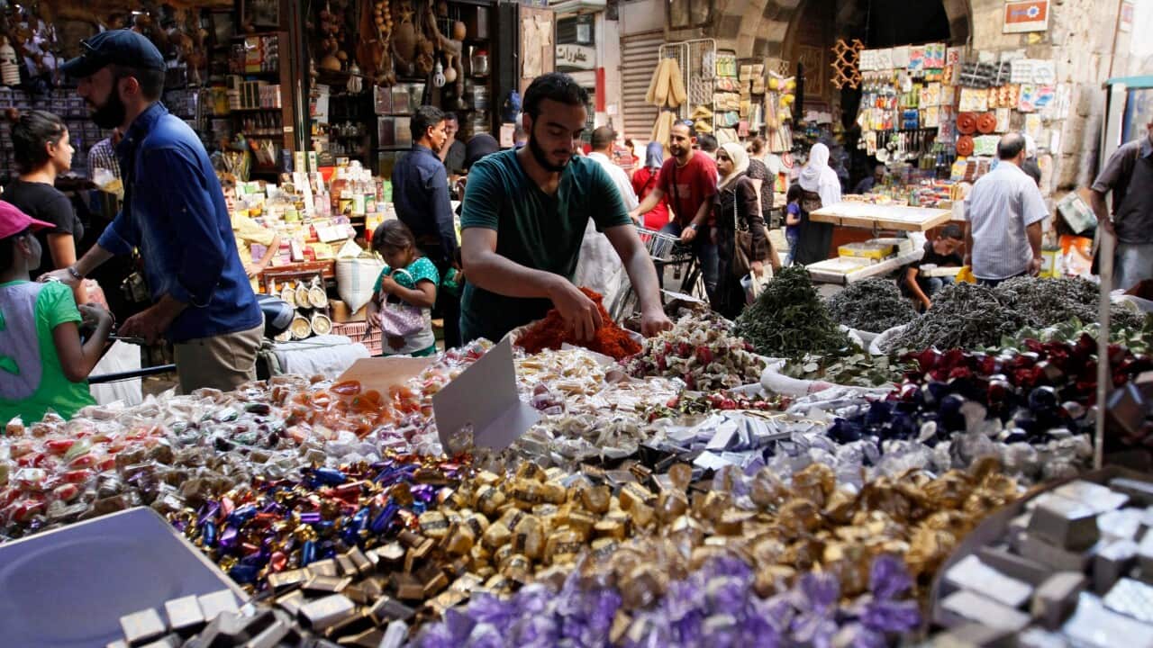 Syrians shop for Eid al-Adha holiday in a market in the Old City of Damascus, Syria