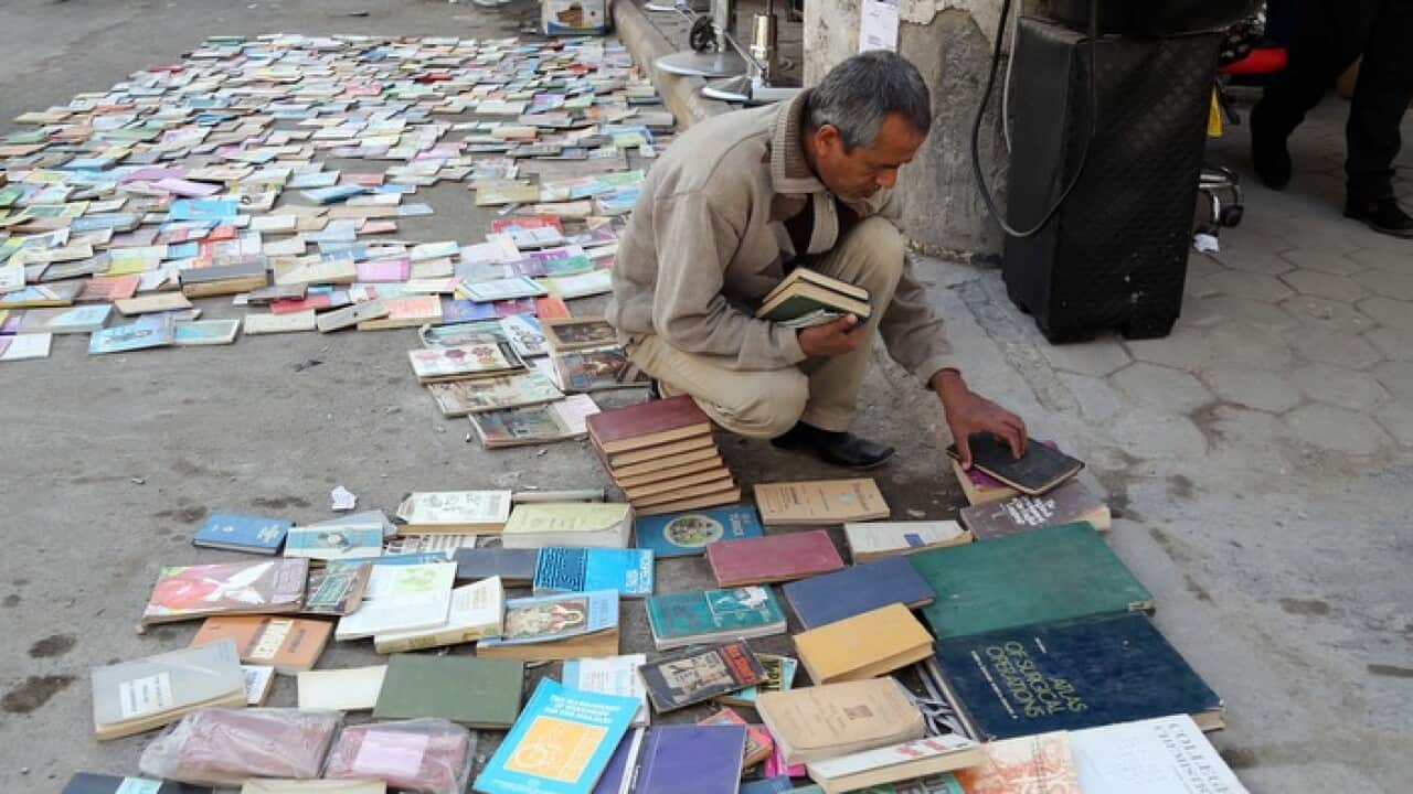 An Iraqi man looks at books on al-Mutanabi Street, home to the book market in central Baghdad
