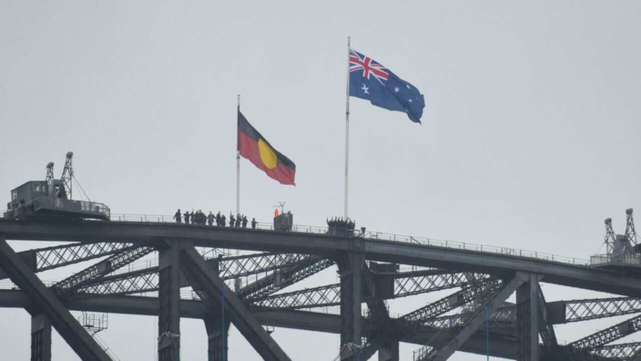 Australian and Aboriginal flags seen on the Harbour Bridge as part of Australia Day celebrations in Sydney, Monday, Jan. 26, 2015. (AAP Image/Joel Carrett) NN ARCHIVING