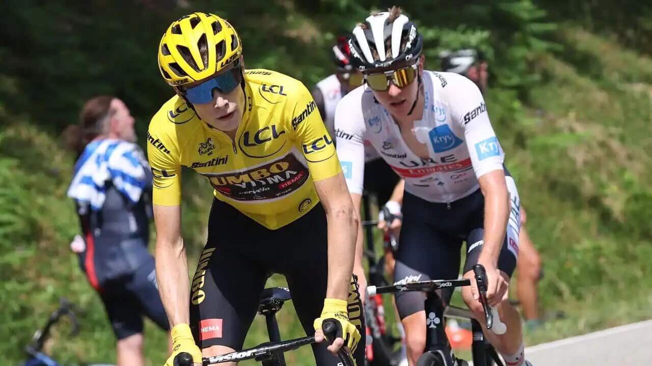 UAE Team Emirates team's Slovenian rider Tadej Pogacar (R) and Jumbo-Visma team's Danish rider Jonas Vingegaard (L) cycle in an ascent during the 16th stage of the 109th edition of the Tour de France.