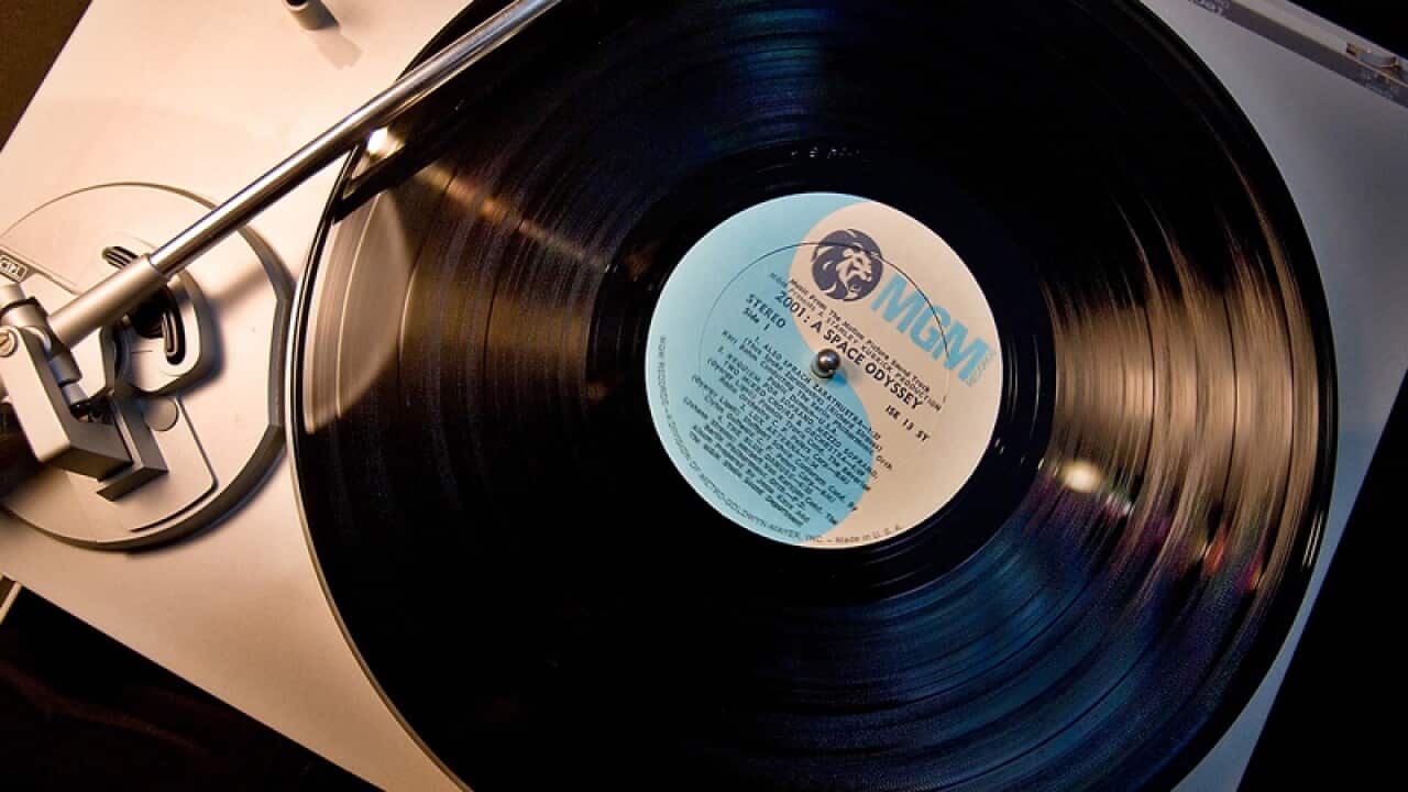 A vinyl spins on a turntable