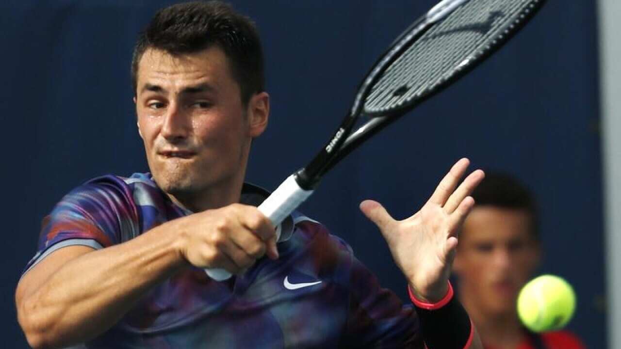 Bernard Tomic returning a shot