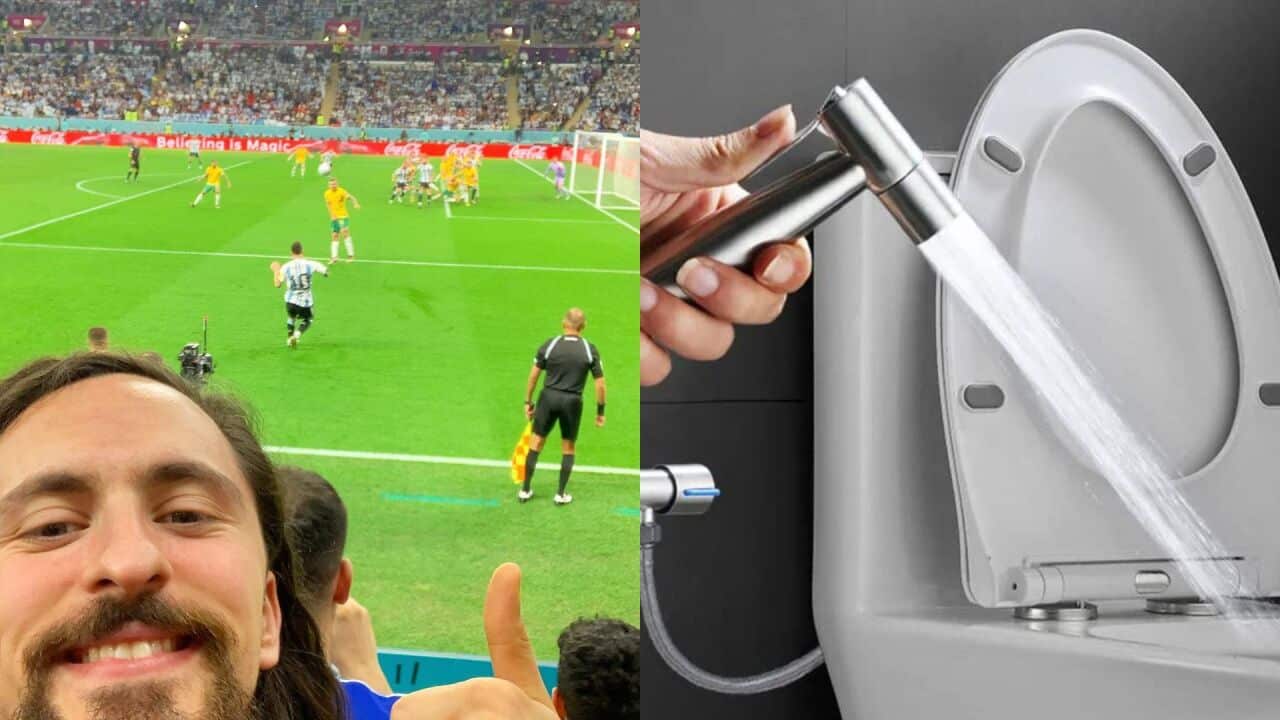 A man poses in front of a football field, next to a toilet.