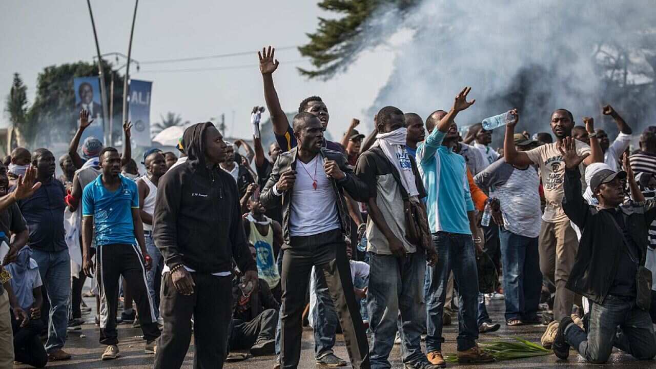 Supporters of Gabonese opposition leader Jean Ping face security forces blocking the demonstration trying to reach the electoral commission in Libreville