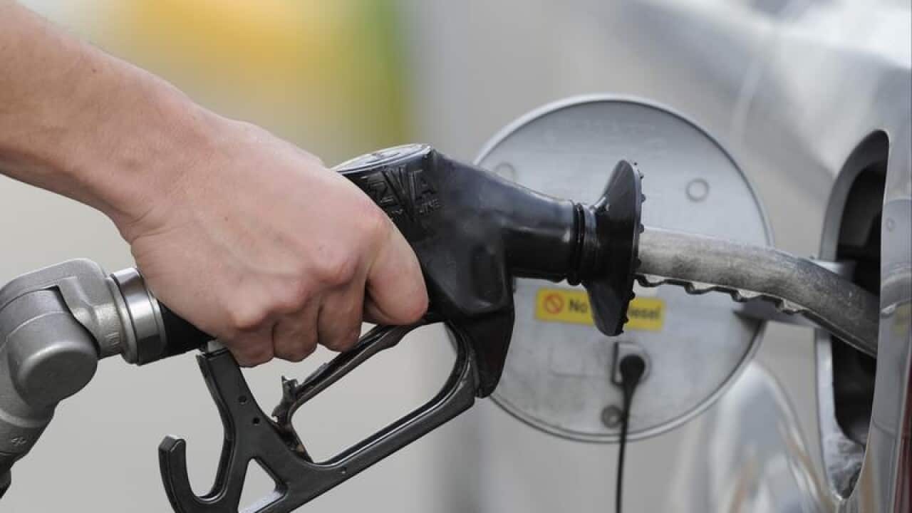 A man pumps petrol at a service station