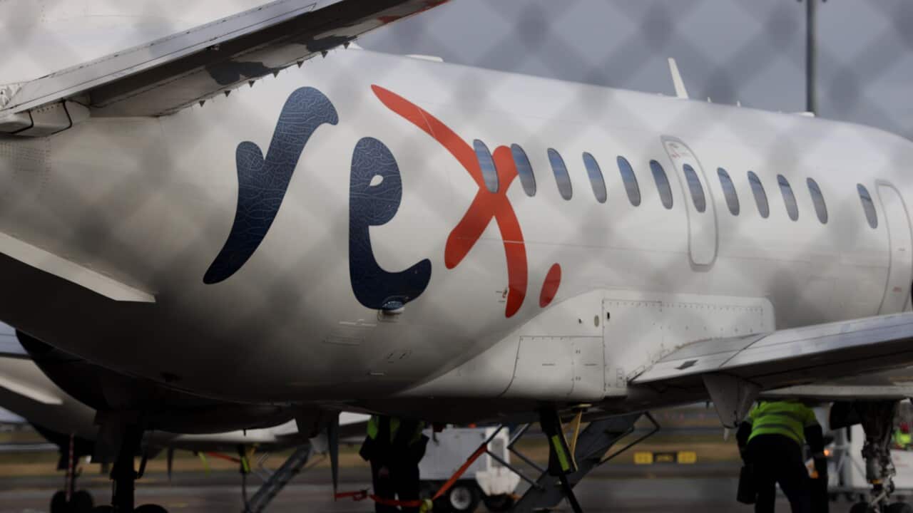 A white aeroplane wth Rex painted on the side