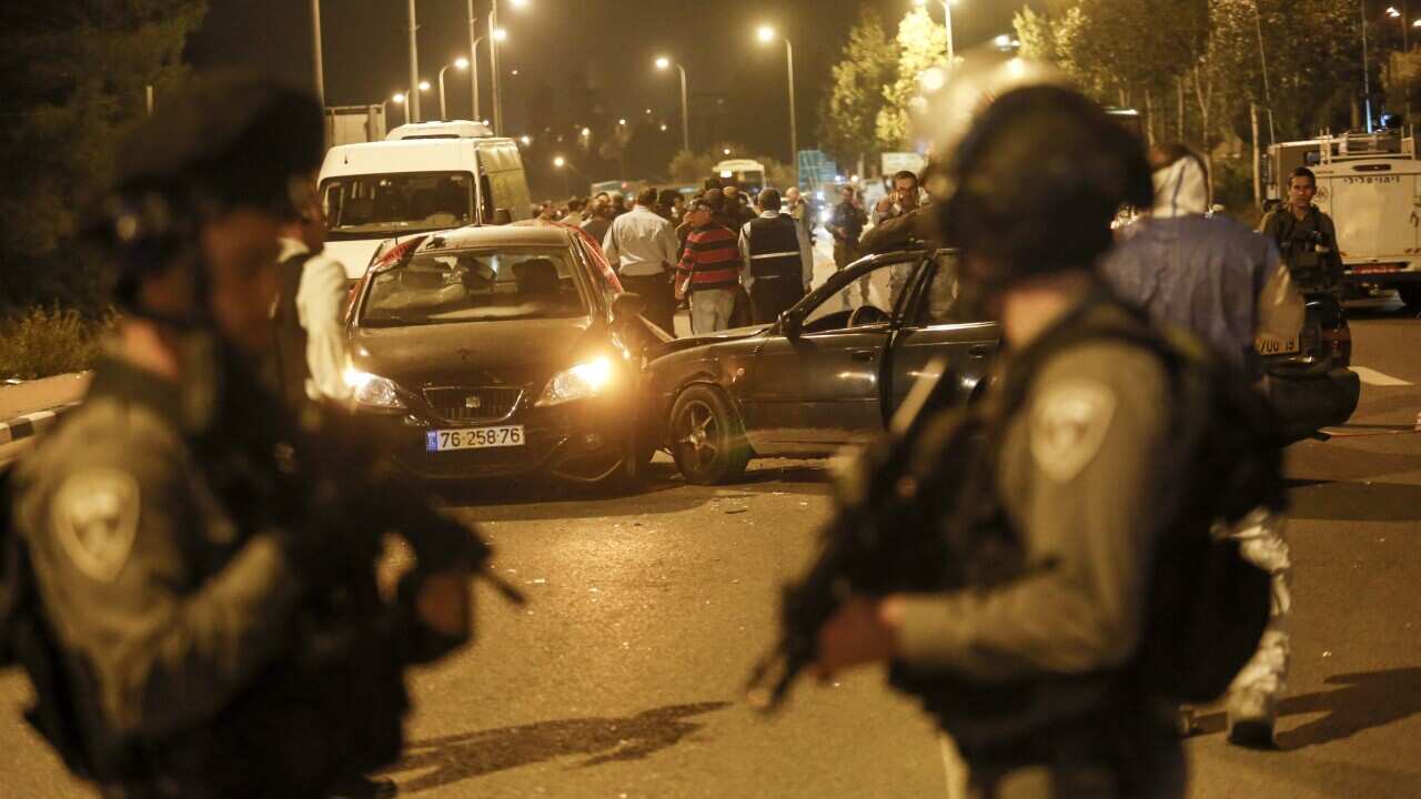 Israeli soldiers at the scene at Gush Etzion junctions, where three Israelis were killed by a Palestinian attacker, next to the Alon Shvut Settlement, near Hebron, West Bank, 19 November 2015.
