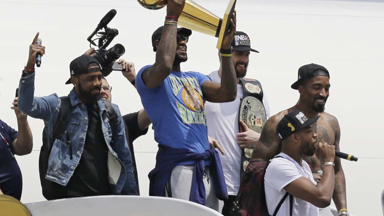LeBron James holds the NBA Championship trophy