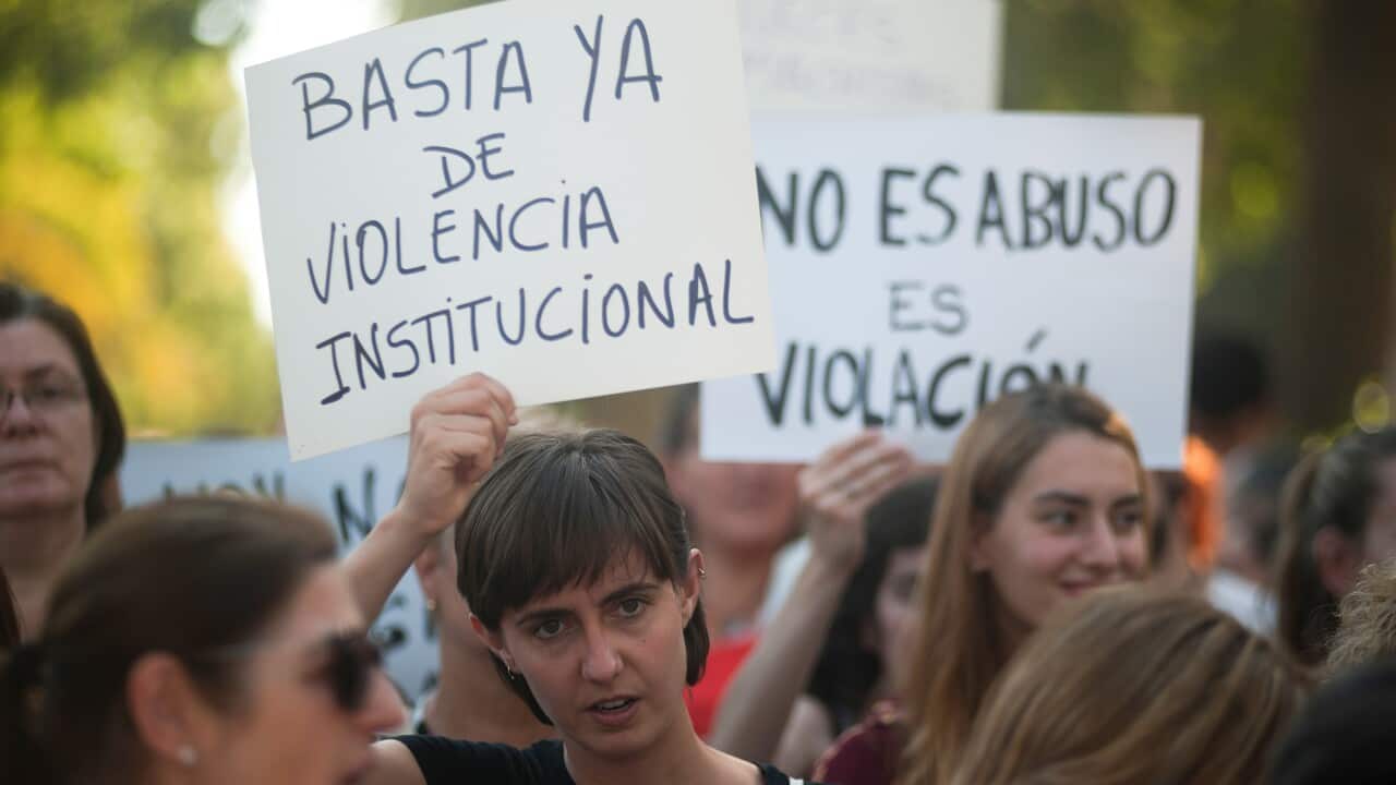 A woman holds a placard during the demonstration in support of a young woman who was raped by seven men in Manresa.