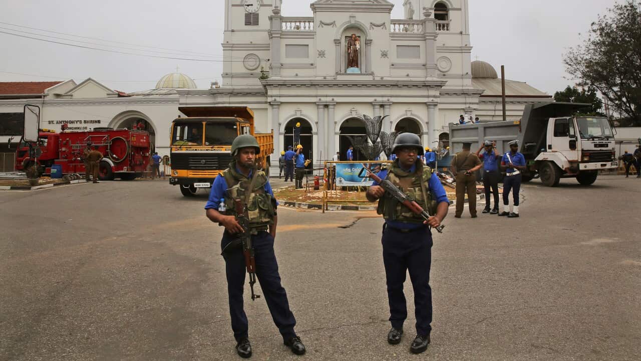 Sri Lankan Naval soldiers stand outside damaged St. Anthony's Church, in Colombo on 27 April.