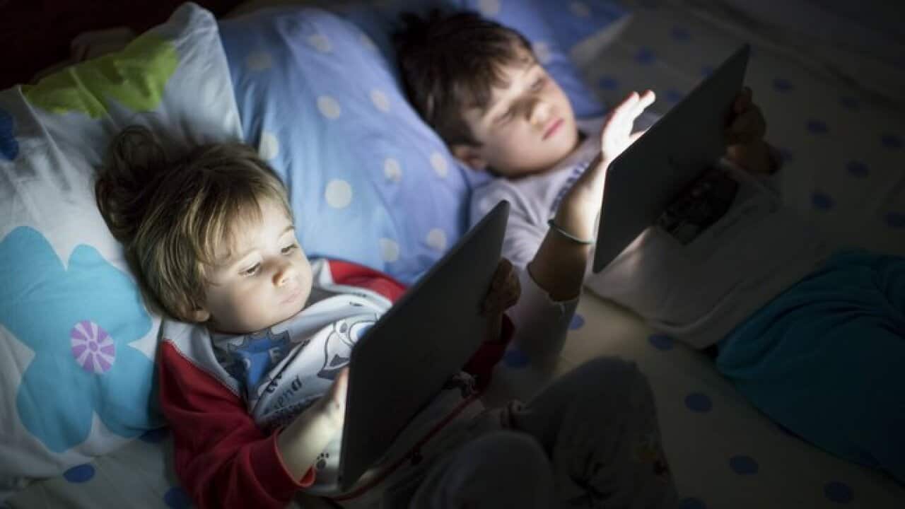 Kids using a digital tablet in the dark