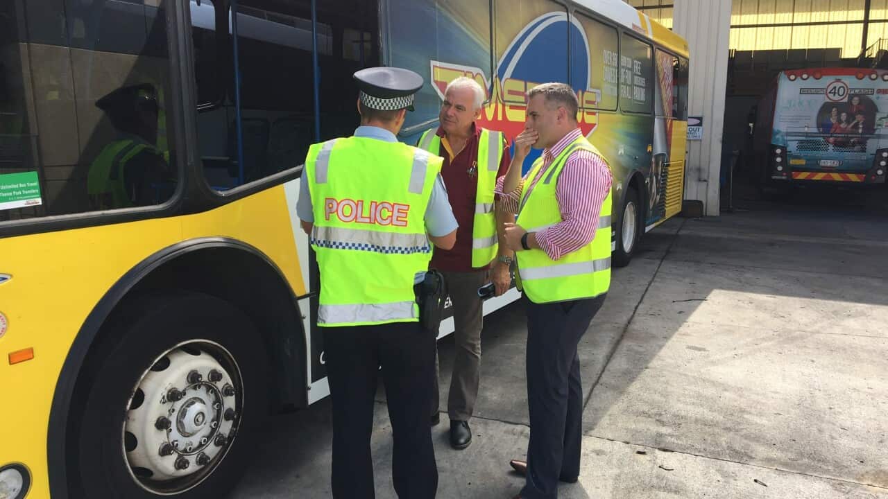 Surfside Buslines general manager Martin Hall (R) discusses the latest attack on a bus on the Gold Coast.