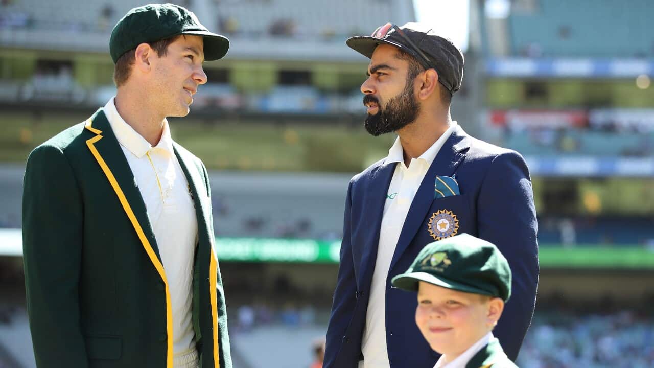 Tim Paine of Australiaand Virat Kohli of India talk before the coin toss as Archie Shiller from the Make A Wish foundation who will be co-captain on Boxing Day looks on during day one of the Third Test match in the series between Australia and India at Me