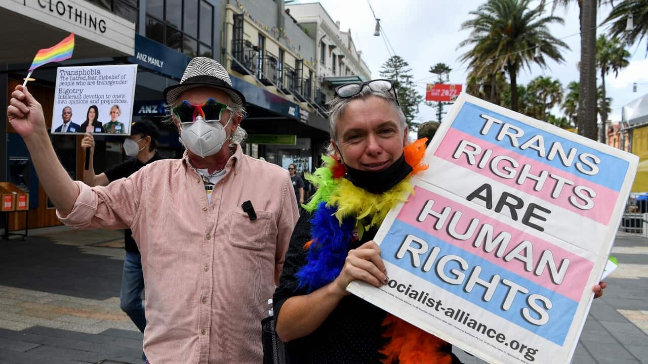 Members of Community Action for Rainbow Rights hold placards as they participate in a protest against candidate for Warringah Katherine Deves at the Manly Corso in Sydney, Thursday, April 21, 2022. (AAP Image/Bianca De Marchi) NO ARCHIVING