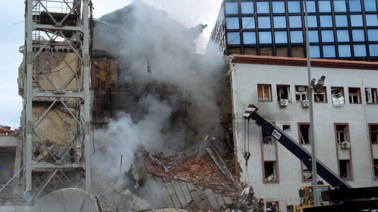 Smoke rising from the ruin of the Serbian state television building bombed by NATO on April 23, 1999