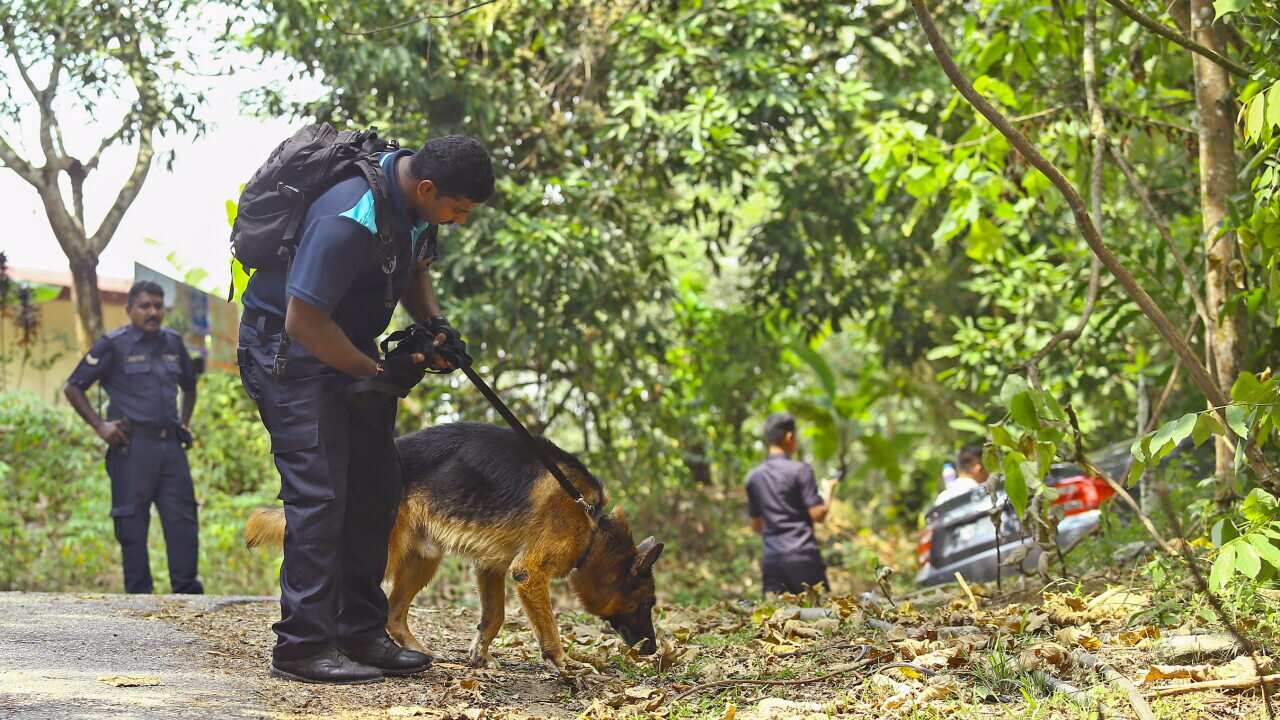 A K9 Unit officer from the Royal Malaysian Police takes part in the search for 15-year-old Nora Quoirin.