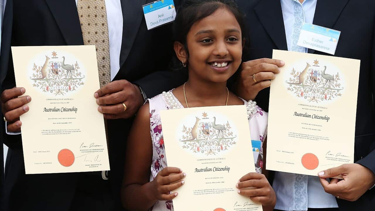 An Indian child receives Australian Citizenship Certificate.