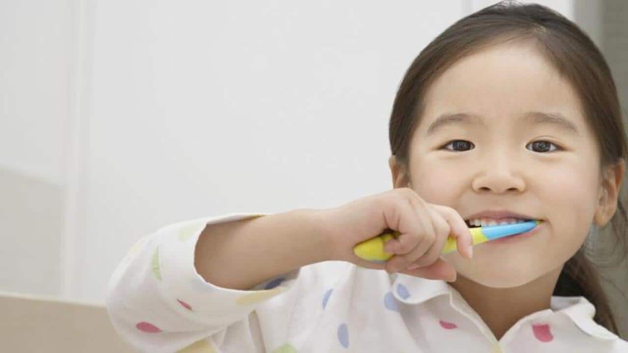 Girl brushing teeth