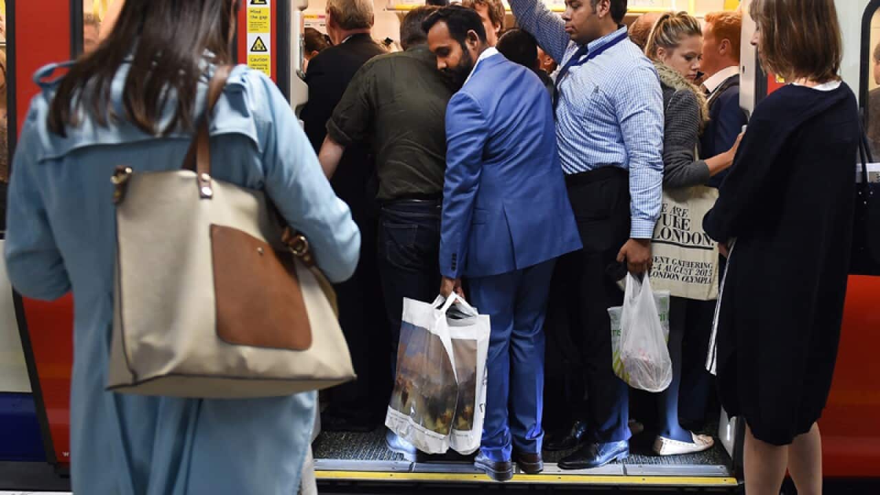 Commuters on an underground train in London