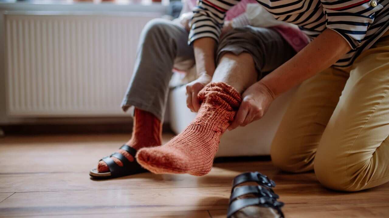 thumbnail_A carer helping a person to dress (Getty).jpg