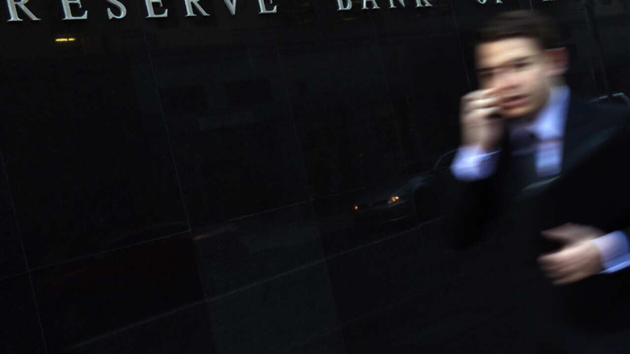 Sydney CBD workers walk past the Reserve Bank of Australia