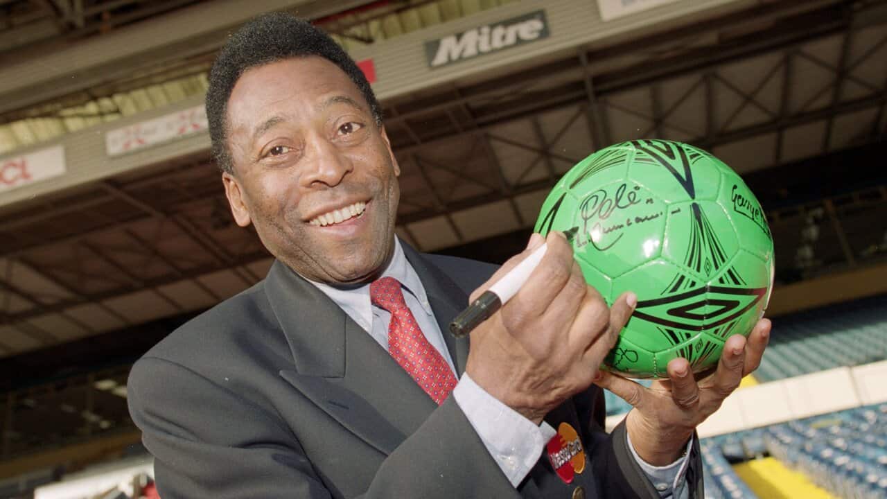 A man signing a football