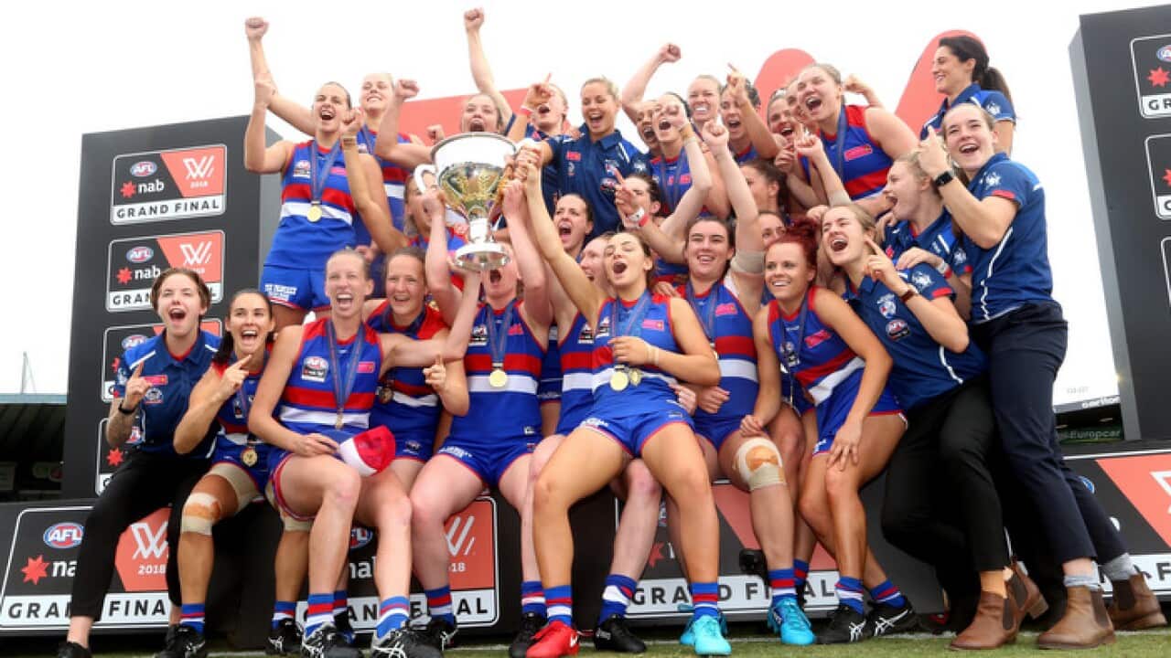 Bulldogs players celebrate winning the AFLW competition