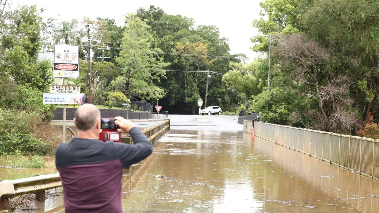 A photographer captures flooding on a Lismore bridge (AAP).