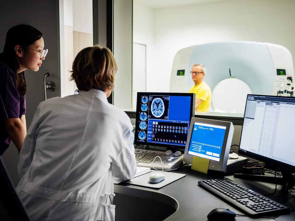 Female Doctor And Nurse Looking At Patient Data Of A CT-Scan