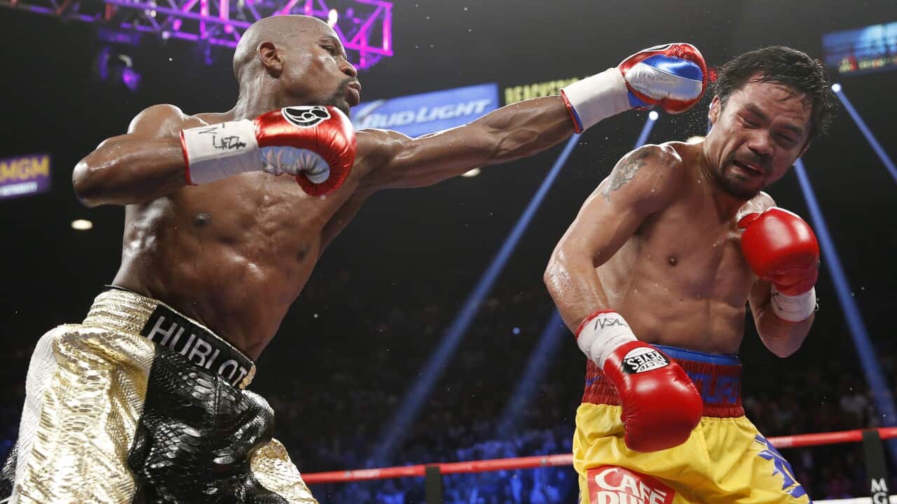 Floyd Mayweather Jr., left, hits Manny Pacquiao, from the Philippines, during their welterweight title fight. (AP)